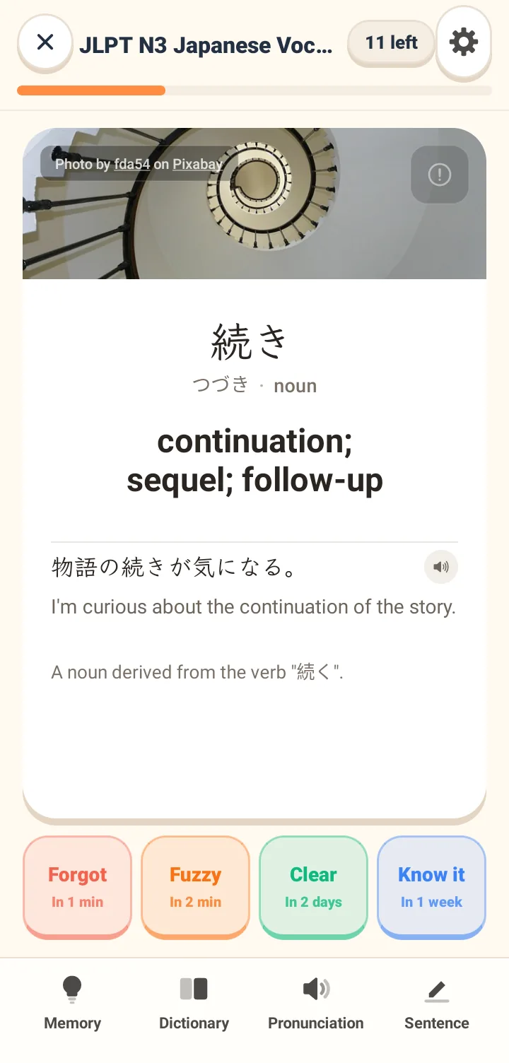 Tomaru flashcard screen showing a vocabulary word with its pronunciation, meaning and two example sentences, above four review rating buttons